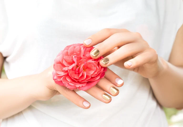 beautiful-female-hands-with-perfect-golden-pink-nail-design-hold-fresh-rose-flower